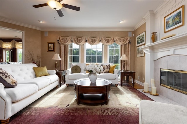 6501 N National Dr, Parkville, MO 64152 - living area with healthy amount of natural light, ceiling fan, a tile fireplace, ornamental molding, and baseboards