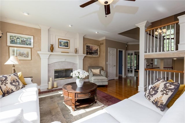 6501 N National Dr, Parkville, MO 64152 - living room featuring wood finished floors, a ceiling fan, ornamental molding, baseboards, and a tile fireplace