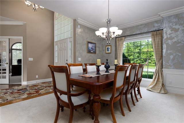 6501 N National Dr, Parkville, MO 64152 - carpeted dining area with a chandelier, ornamental molding, plenty of natural light, wallpapered walls, and a wainscoted wall