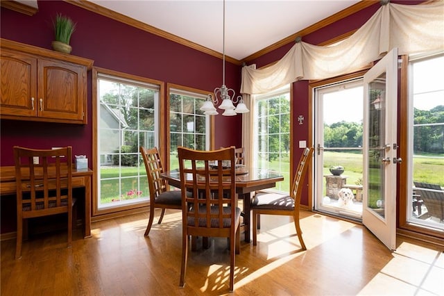 6501 N National Dr, Parkville, MO 64152 - dining area featuring ornamental molding, wood finished floors, healthy amount of natural light, and a chandelier