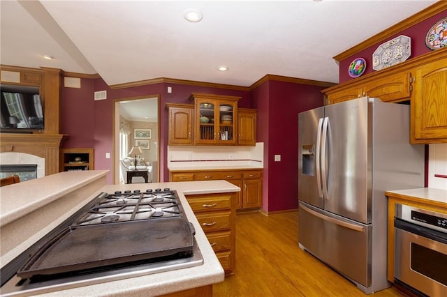 6501 N National Dr, Parkville, MO 64152 - kitchen featuring appliances with stainless steel finishes, light wood-type flooring, brown cabinets, light countertops, and recessed lighting
