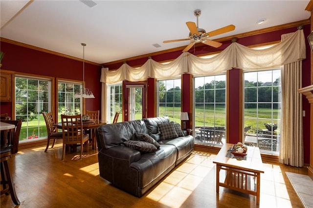6501 N National Dr, Parkville, MO 64152 - living area with ceiling fan, crown molding, plenty of natural light, and wood finished floors