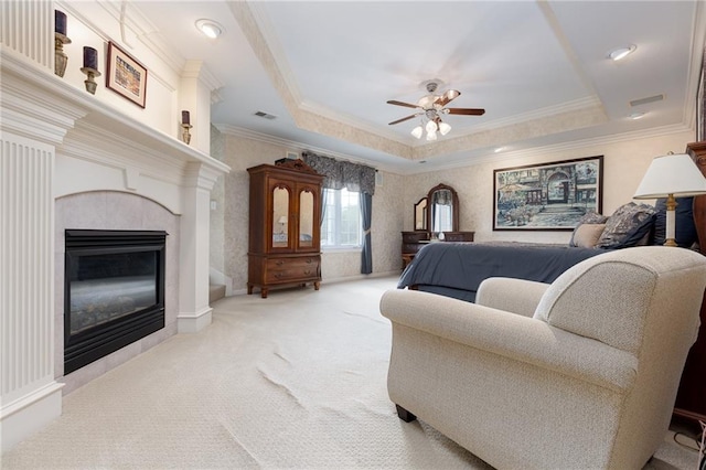 6501 N National Dr, Parkville, MO 64152 - bedroom featuring carpet, crown molding, a tray ceiling, a tile fireplace, and ceiling fan