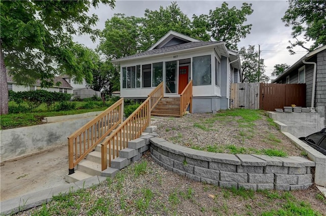 6117 Harrison St, Kansas City, MO 64110 - view of front of property featuring a sunroom and a gate