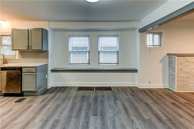 6117 Harrison St, Kansas City, MO 64110 - unfurnished living room featuring wood finished floors and baseboards