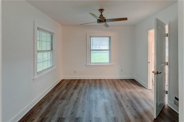 6117 Harrison St, Kansas City, MO 64110 - spare room featuring healthy amount of natural light, wood finished floors, and baseboards