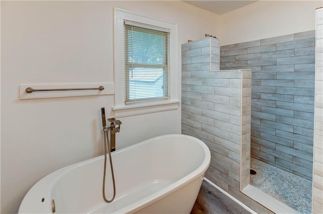 6117 Harrison St, Kansas City, MO 64110 - full bath with a soaking tub, a walk in shower, and wood finished floors