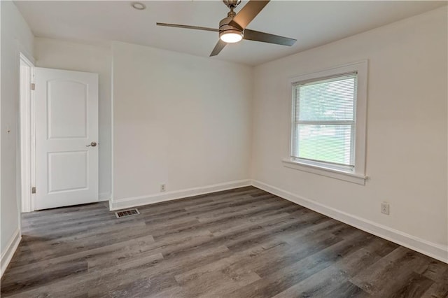 6117 Harrison St, Kansas City, MO 64110 - unfurnished room featuring dark wood finished floors, a ceiling fan, and baseboards