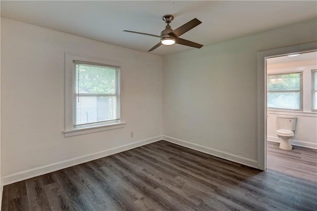 6117 Harrison St, Kansas City, MO 64110 - unfurnished room featuring healthy amount of natural light, dark wood finished floors, and ceiling fan