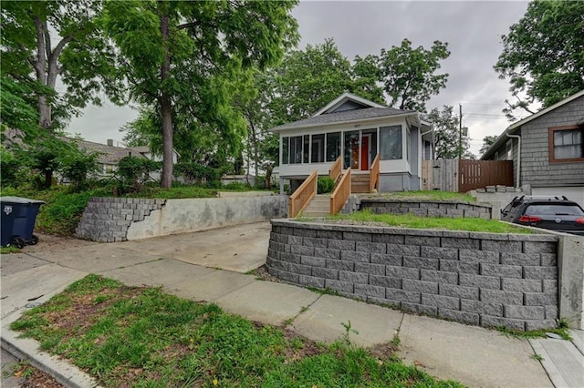 6117 Harrison St, Kansas City, MO 64110 - bungalow-style home featuring a sunroom