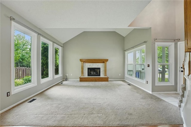 14876 S Summit St, Olathe, KS 66062 - unfurnished living room featuring a tile fireplace, light carpet, and vaulted ceiling