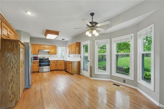 14876 S Summit St, Olathe, KS 66062 - kitchen featuring appliances with stainless steel finishes, light countertops, light wood-type flooring, and brown cabinets