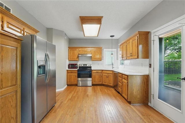 14876 S Summit St, Olathe, KS 66062 - kitchen featuring stainless steel appliances, light wood-type flooring, healthy amount of natural light, and light countertops