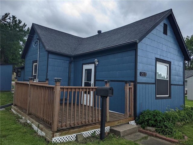 203 W 4th St, Holden, MO 64040 - back of property featuring a wooden deck and roof with shingles