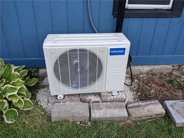 203 W 4th St, Holden, MO 64040 - exterior view of a cooling unit and board and batten siding