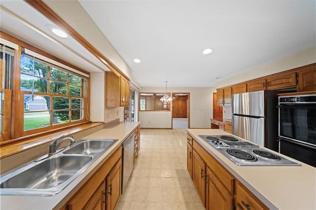 9509 W 116th Ter, Overland Park, KS 66210 - kitchen featuring stainless steel appliances, light countertops, recessed lighting, brown cabinetry, and decorative light fixtures