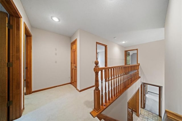 9509 W 116th Ter, Overland Park, KS 66210 - hall featuring an upstairs landing, light colored carpet, recessed lighting, and a textured ceiling