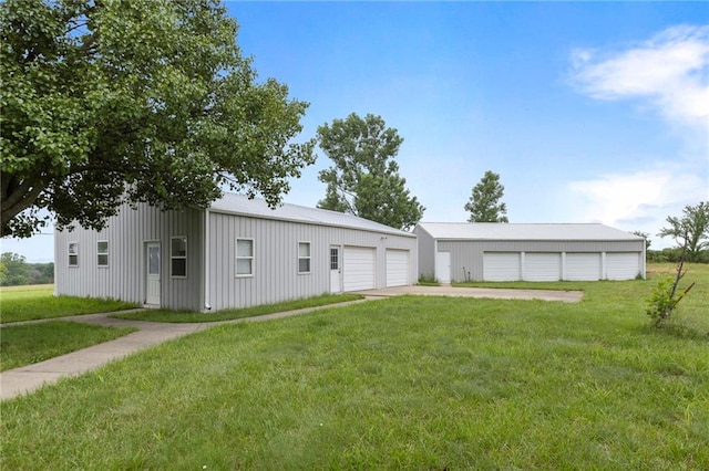 25549 Chieftain Rd, Lawrence, KS 66044 - view of front of house with a front yard, a garage, and an outbuilding