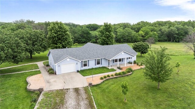 25549 Chieftain Rd, Lawrence, KS 66044 - view of front of property featuring driveway, an attached garage, a front lawn, and a porch