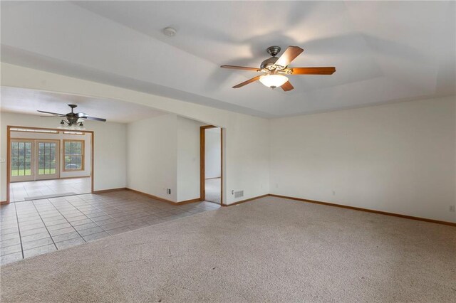 25549 Chieftain Rd, Lawrence, KS 66044 - empty room with a ceiling fan, light colored carpet, baseboards, and light tile patterned flooring