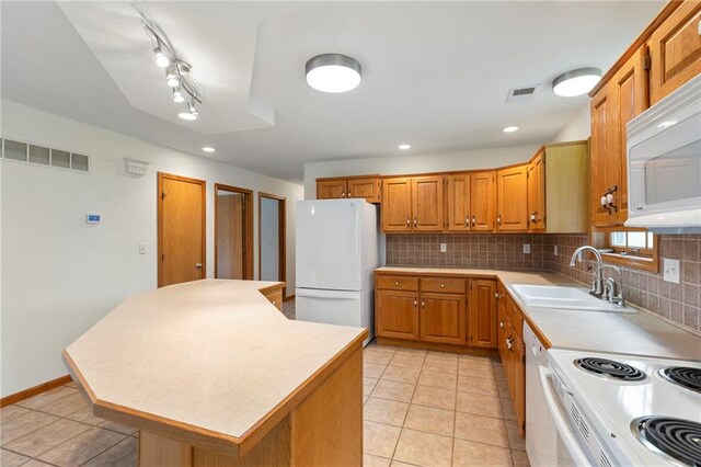 25549 Chieftain Rd, Lawrence, KS 66044 - kitchen with white appliances, a sink, backsplash, brown cabinets, and recessed lighting