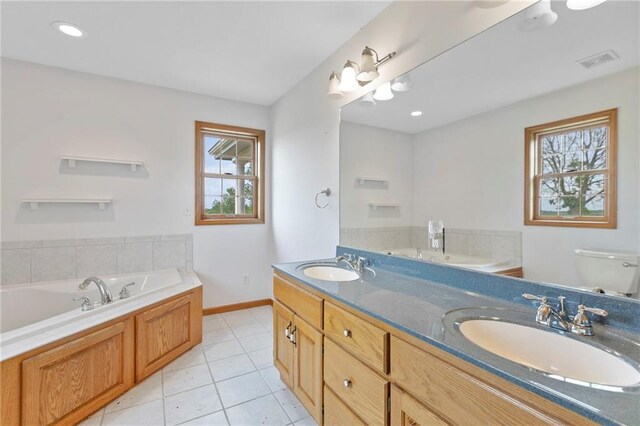 25549 Chieftain Rd, Lawrence, KS 66044 - bathroom with healthy amount of natural light, a bath, double vanity, and baseboards