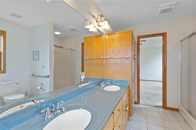 25549 Chieftain Rd, Lawrence, KS 66044 - bathroom with double vanity, toilet, tile patterned flooring, and a stall shower