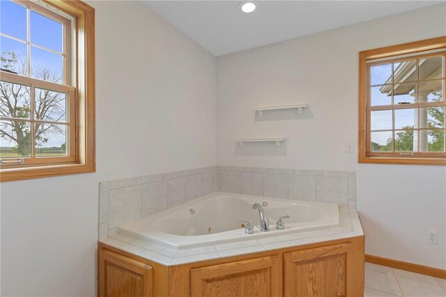 25549 Chieftain Rd, Lawrence, KS 66044 - bathroom with healthy amount of natural light, a tub with jets, tile patterned floors, baseboards, and recessed lighting