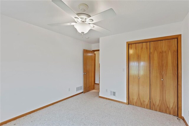 25549 Chieftain Rd, Lawrence, KS 66044 - unfurnished bedroom featuring carpet flooring, baseboards, a closet, and ceiling fan