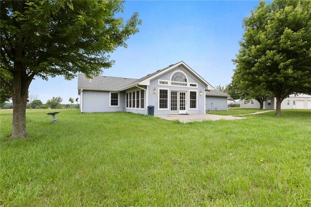 25549 Chieftain Rd, Lawrence, KS 66044 - back of house featuring a lawn and a patio