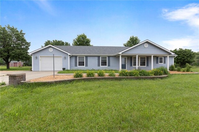 25549 Chieftain Rd, Lawrence, KS 66044 - ranch-style home with an attached garage, concrete driveway, a front yard, and a porch