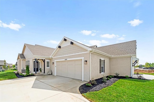 8215 Aurora St, Lenexa, KS 66220 - view of front of house featuring an attached garage, a front yard, concrete driveway, and stucco siding