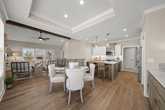 8215 Aurora St, Lenexa, KS 66220 - dining space with a ceiling fan, recessed lighting, light wood-style floors, ornamental molding, and a raised ceiling