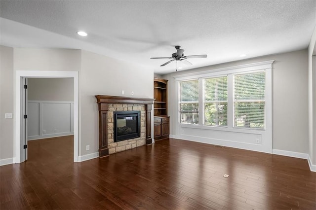 9154 Shady Bend Rd, Lenexa, KS 66227 - unfurnished living room with ceiling fan, wood finished floors, a fireplace, recessed lighting, and a textured ceiling