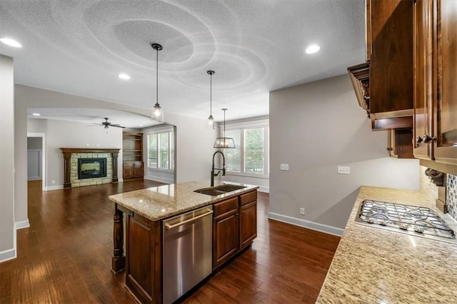 9154 Shady Bend Rd, Lenexa, KS 66227 - kitchen with appliances with stainless steel finishes, a tile fireplace, ceiling fan, a textured ceiling, and recessed lighting