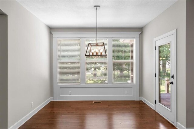 9154 Shady Bend Rd, Lenexa, KS 66227 - unfurnished dining area featuring dark wood-type flooring and baseboards