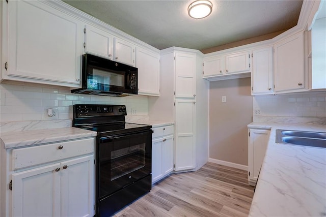 3512 Harvard Ave, Independence, MO 64052 - kitchen with black appliances, white cabinetry, and light wood finished floors