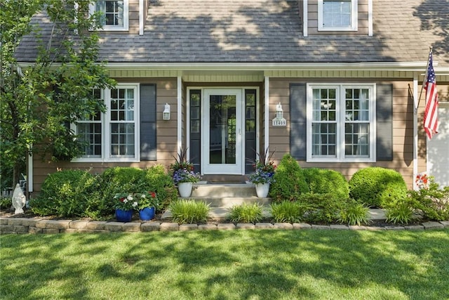 11409 Riley St, Overland Park, KS 66210 - view of exterior entry featuring a yard and roof with shingles