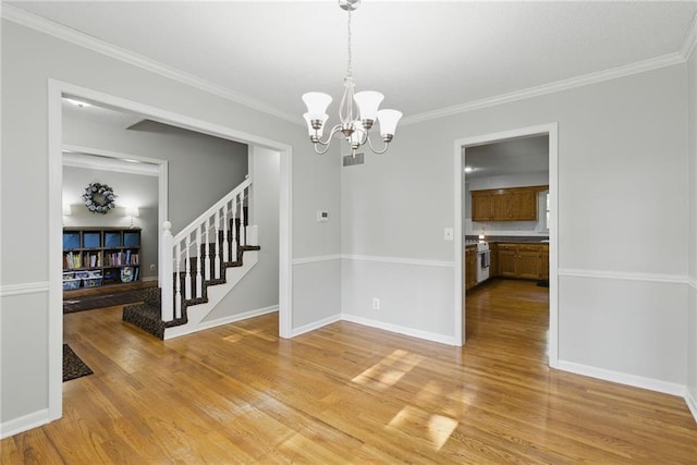 11409 Riley St, Overland Park, KS 66210 - unfurnished dining area featuring light wood-style flooring, stairway, a chandelier, and ornamental molding