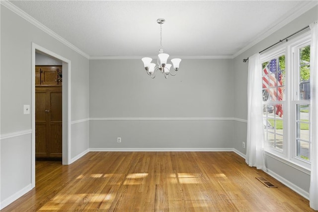11409 Riley St, Overland Park, KS 66210 - empty room with light wood finished floors, a chandelier, and crown molding
