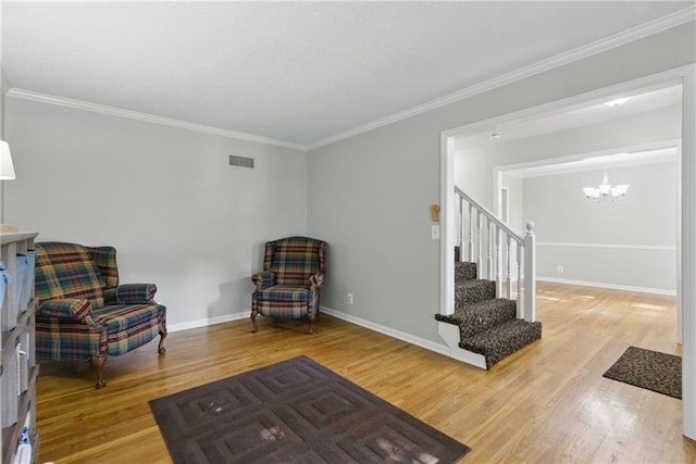 11409 Riley St, Overland Park, KS 66210 - living area with a chandelier, wood finished floors, crown molding, and stairs