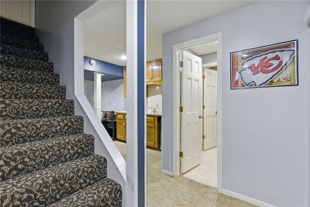 11409 Riley St, Overland Park, KS 66210 - stairs featuring carpet floors and baseboards