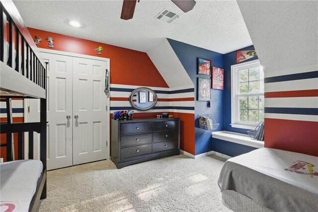 11409 Riley St, Overland Park, KS 66210 - carpeted bedroom with a textured ceiling, a closet, and a ceiling fan