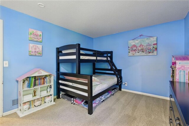 11409 Riley St, Overland Park, KS 66210 - carpeted bedroom featuring baseboards and a textured ceiling