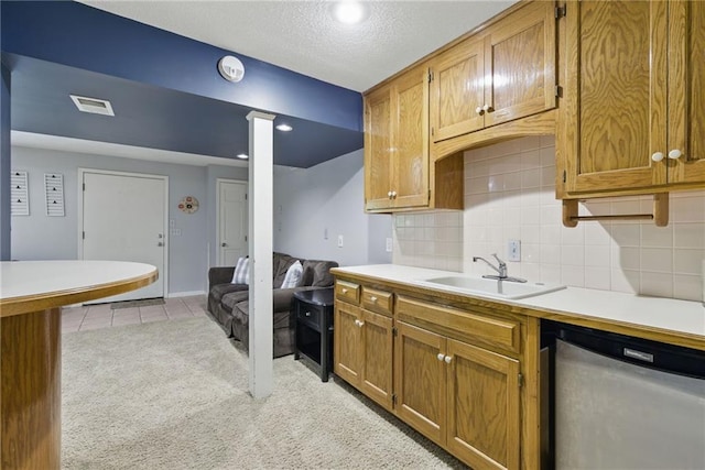 11409 Riley St, Overland Park, KS 66210 - kitchen with light countertops, brown cabinetry, tasteful backsplash, and dishwasher