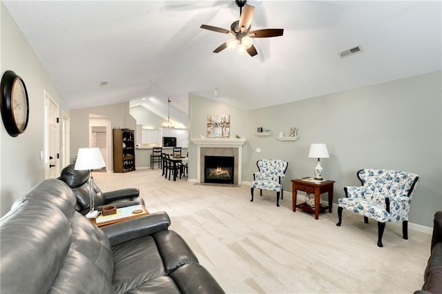 7226 Meadow View St, Shawnee, KS 66227 - living room with vaulted ceiling, light carpet, a ceiling fan, baseboards, and a tile fireplace