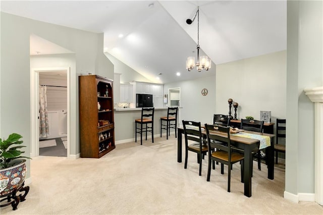 7226 Meadow View St, Shawnee, KS 66227 - dining room with light colored carpet, lofted ceiling, a chandelier, and baseboards
