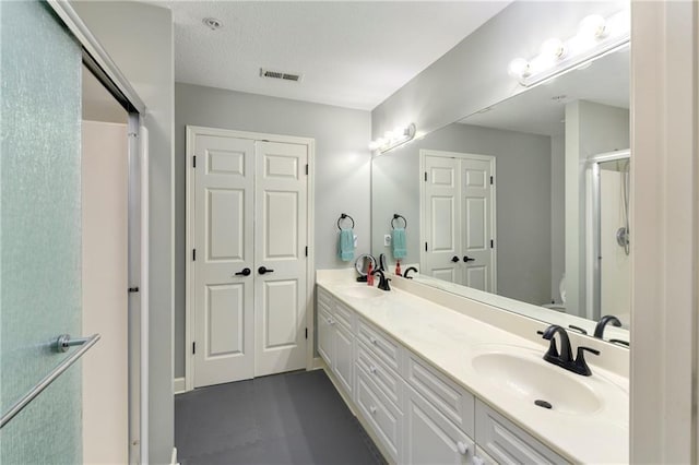 7226 Meadow View St, Shawnee, KS 66227 - bathroom featuring double vanity, a shower with door, and toilet
