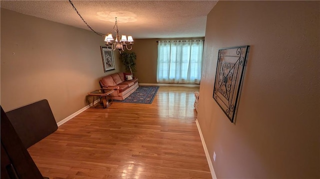 2006 Colonial Dr, Pittsburg, KS 66762 - dining room with a textured ceiling, wood finished floors, a chandelier, and baseboards