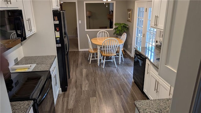 2006 Colonial Dr, Pittsburg, KS 66762 - kitchen featuring black appliances, dark wood-style flooring, white cabinetry, light stone countertops, and baseboards